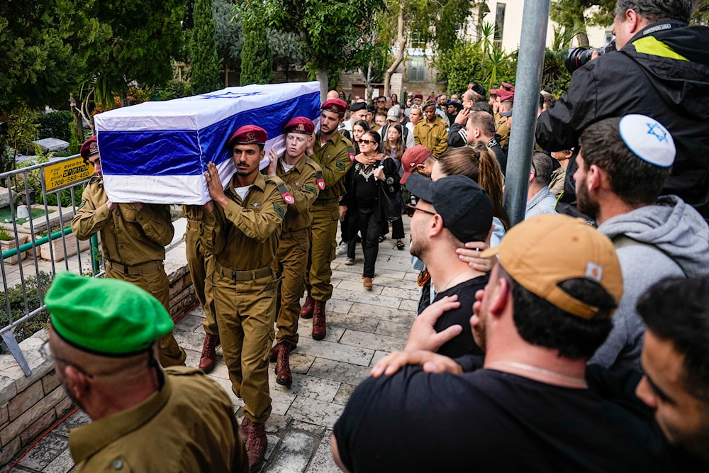Israeli soldiers carry the casket of Israeli solider Staff Sergeant David Sasson during his funeral in 'Netanya', occupied Palestine, March 7, 2024 (AP)
