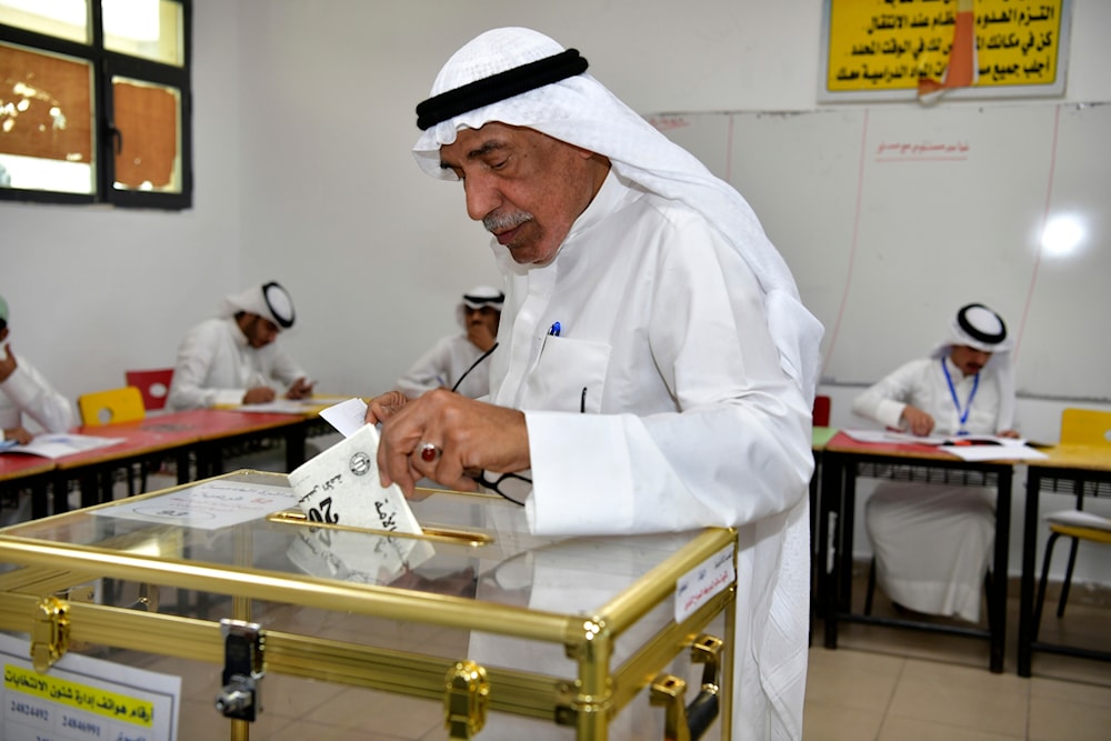 A man casts his vote for the National Assembly elections at Salem Al Nawaf school in Al Riqqa district, Kuwait, Thursday, April 4, 2024. (AP)