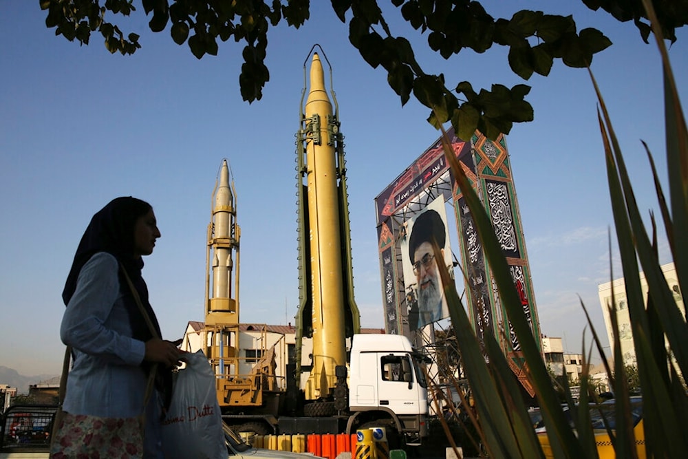 A Ghadr-H missle, center, a solid-fuel surface-to-surface Sejjil missile and a portrait of the Supreme Leader Ayatollah Ali Khamenei are on display, Sept. 24, 2017 (AP)