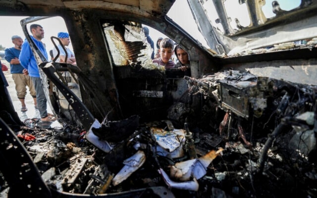 Palestinians inspect the site where World Central Kitchen workers were killed in Deir al-Balah, Gaza Strip, April 2, 2024. (AP)