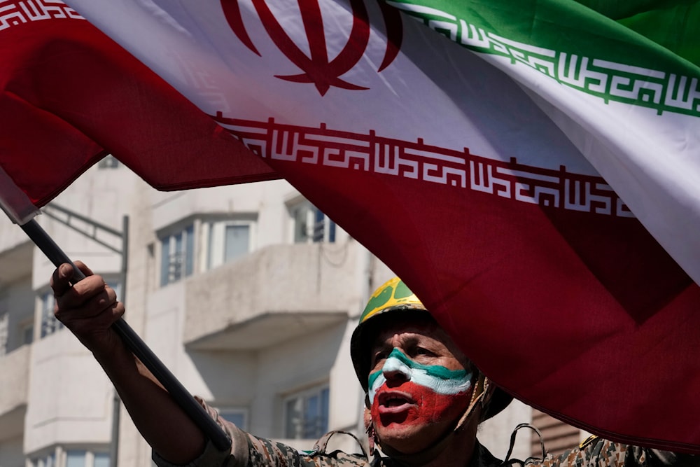 A man chants slogans as he waves the Iranian flag in the annual rally to mark Quds Day, or Jerusalem Day, in support of Palestinians, in Tehran, Iran, Friday, April 5, 2024. (AP)
