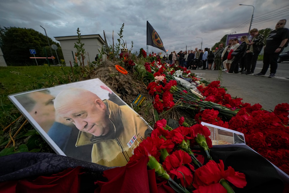 A portrait of the owner of private military company Wagner Group Yevgeny Prigozhin lays at an informal memorial next to the former 'PMC Wagner Centre' in St. Petersburg, Russia on Aug. 24, 2023. (AP)