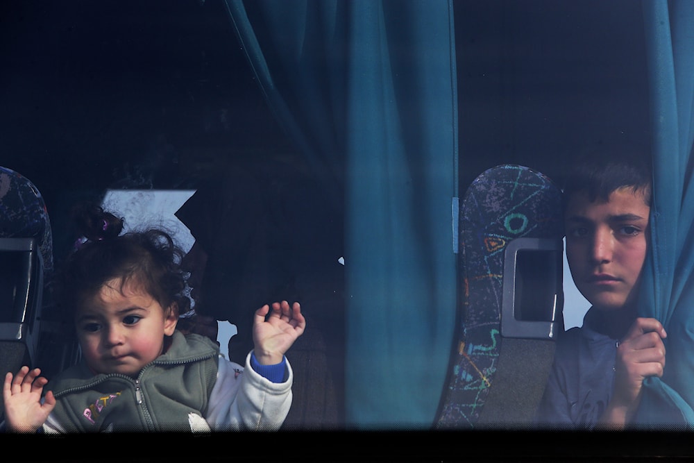 Young migrants from Syria sit in a bus as they arrive at a refugees camp at Kokkinotrimithia outside of the capital Nicosia, Cyprus, on Saturday, Feb. 4, 2017. (AP)