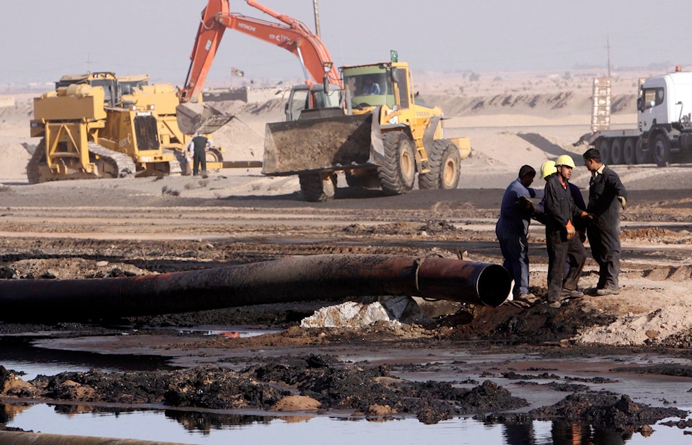 In this Dec. 14, 2011 file photo, workers repair oil pipelines at Rumaila oil fields, near the southern Iraqi city of Basra. (AP)