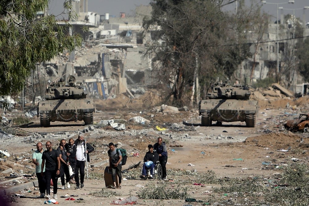 Palestinians flee from northern Gaza as Israeli tanks block the Salah al-Din road in the central Gaza Strip on Friday, Nov. 24, 2023. (AP)