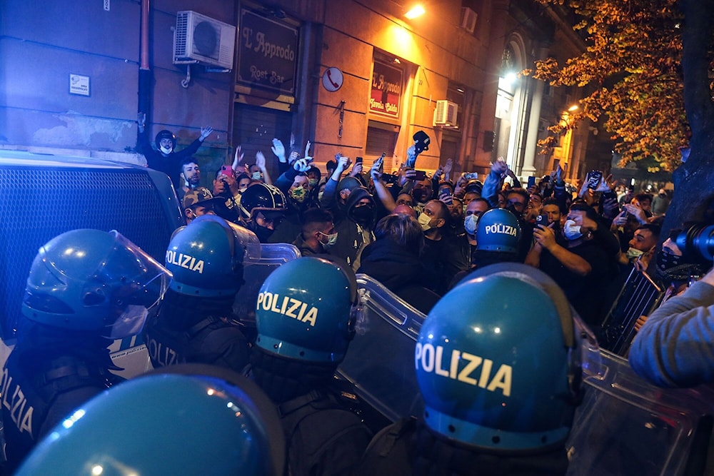 Protesters poured into the streets of Naples where some police vehicles were targeted by demonstrators on October 24, 2020. (AFP)