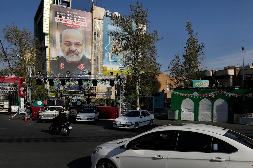 A banner showing a portrait of the late Islamic Revolution Guard  Corps Gen. Mohammad Reza Zahedi who was killed by an Israeli airstrike in Syria, on a building at the Felestin (Palestine) Sq. in downtown Tehran, Iran, April 3, 2024 (AP)
