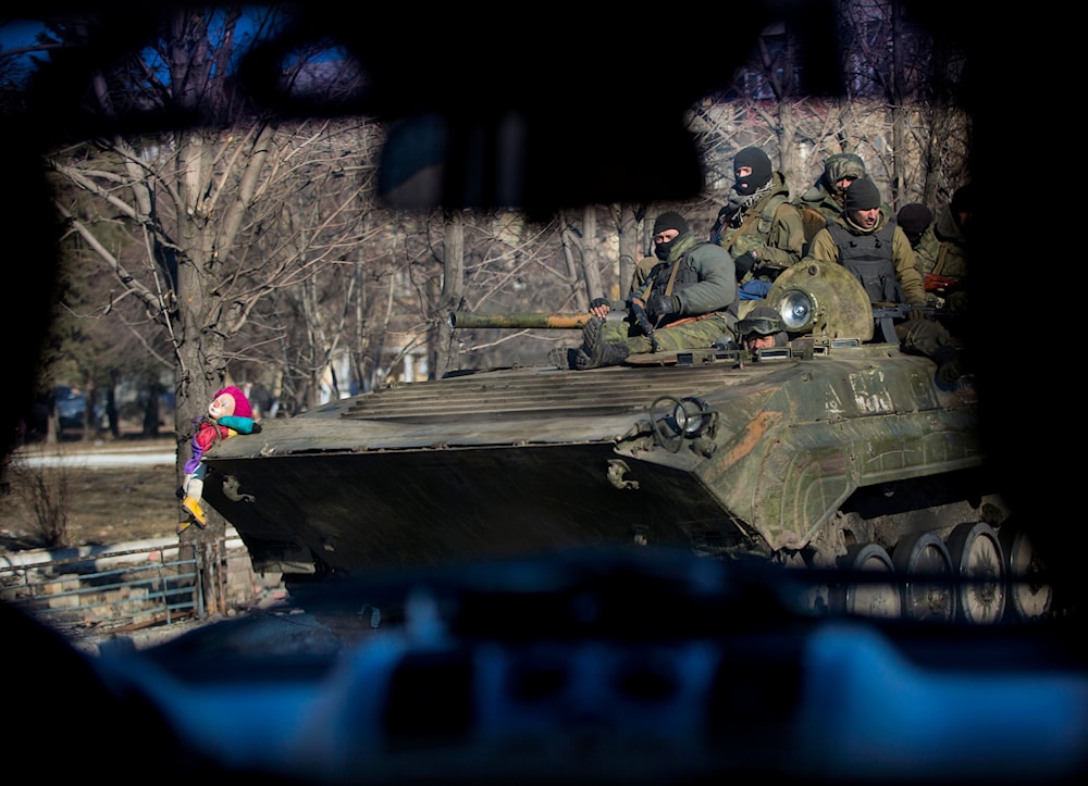 A clown doll is attached to the front of an armored transporter in Debaltseve, Ukraine, Sunday, Feb. 22, 2015.(AP)