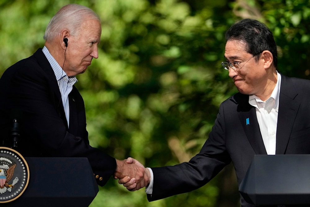 U.S. President Joe Biden, left, shakes hands with Japan's Prime Minister Fumio Kishida during a joint news conference with South Korean President Yoon Suk Yeol, not visible, on Aug. 18, 2023 (AP)