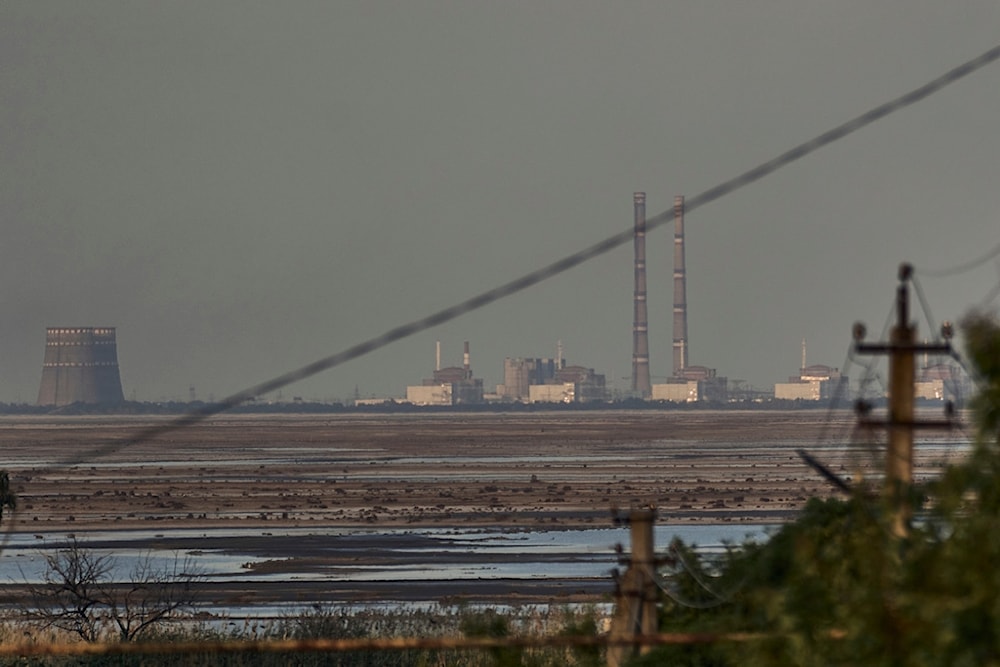 The Zaporizhzhia nuclear power plant, Europe's largest, is seen in the background of the shallow Kakhovka Reservoir after the dam collapse, in Energodar, Russian-occupied Ukraine, June 27, 2023. 