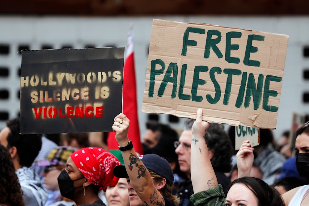 Protesters hold posters in support of Palestinians calling for a ceasefire in Gaza, March 10, 2024, in the Hollywood section of Los Angeles (AP)