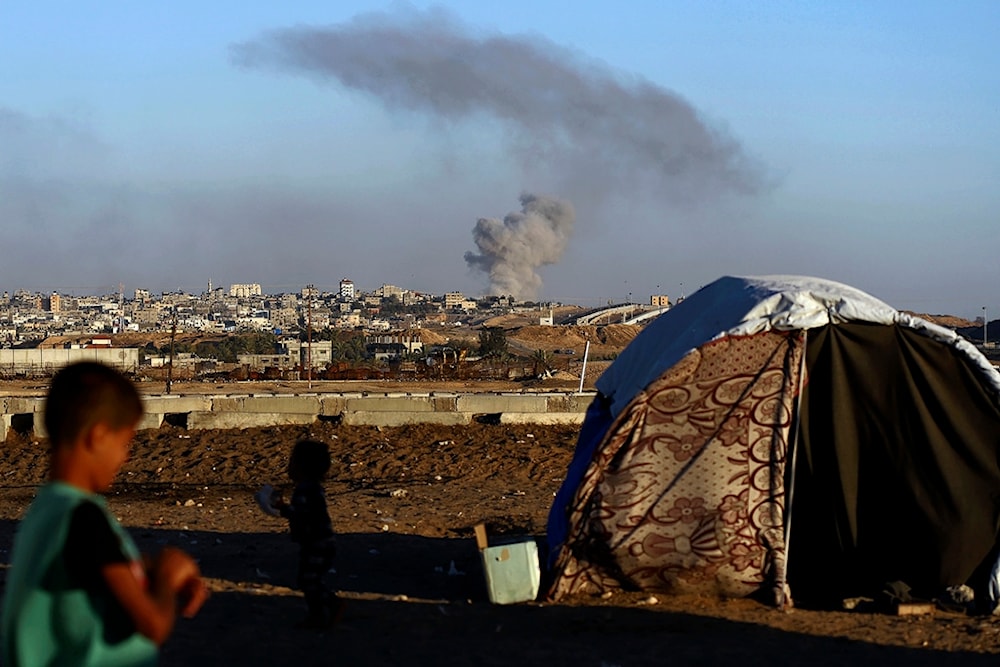 Smoke rises following an Israeli airstrike on buildings near the separating wall between Egypt and Rafah, southern Gaza Strip, Tuesday, May 7, 2024. (AP)