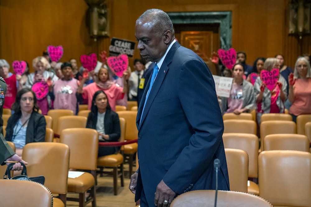 Protestors opposing the war hold signs as Secretary of Defense Lloyd Austin arrives for a hearing at Capitol Hill, Wednesday, May 8, 2024, in Washington. (AP)