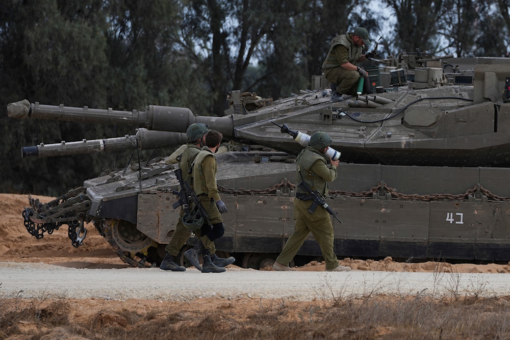 Israeli occupation soldiers are seen near the Gaza Strip, in southern occupied Palestine, May 7, 2024 (AP)