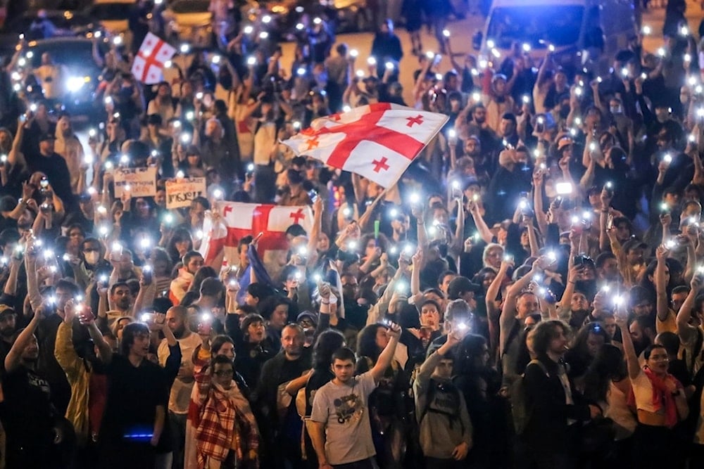 Demonstrators wave Georgian national flags during an opposition protest against foreign influence law in the center of Tbilisi, Georgia, on Thursday, May 2, 2024. (AP)