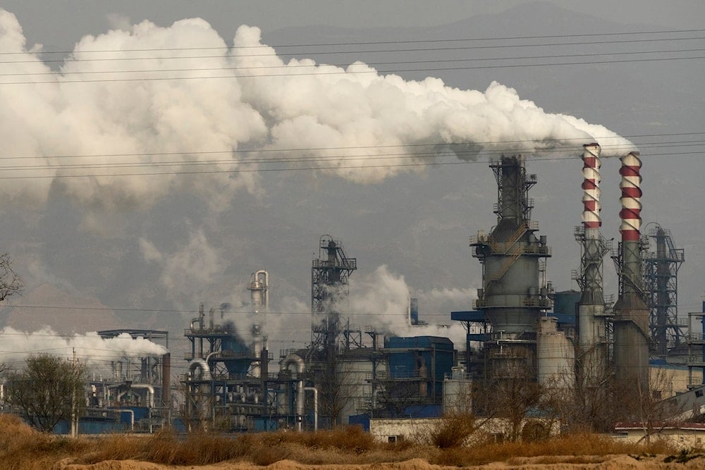 Smoke and steam rise from a coal processing plant in Hejin in central China's Shanxi Province on Nov. 28, 2019. (AP)