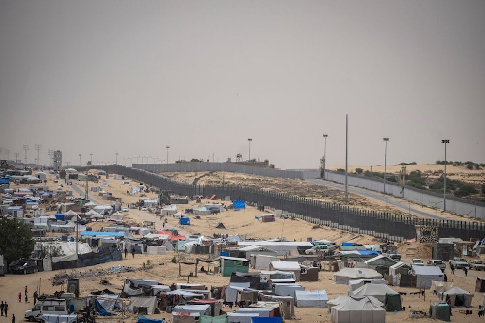 Palestinians displaced by the Israeli air and ground offensive on the Gaza Strip walk through a makeshift tent camp in Rafah, on the border with Egypt Gaza, Friday, May 10, 2024. (AP)