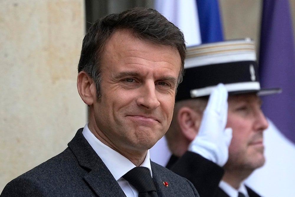 French President Emmanuel Macron waits on the steps of the Elysee Palace, Monday, March 11, 2024 in Paris (AP)