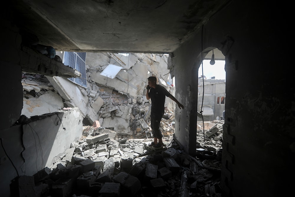 Palestinians look at the destruction after an Israeli strike on residential building in Rafah, Gaza Strip, on May 7, 2024. (AP)