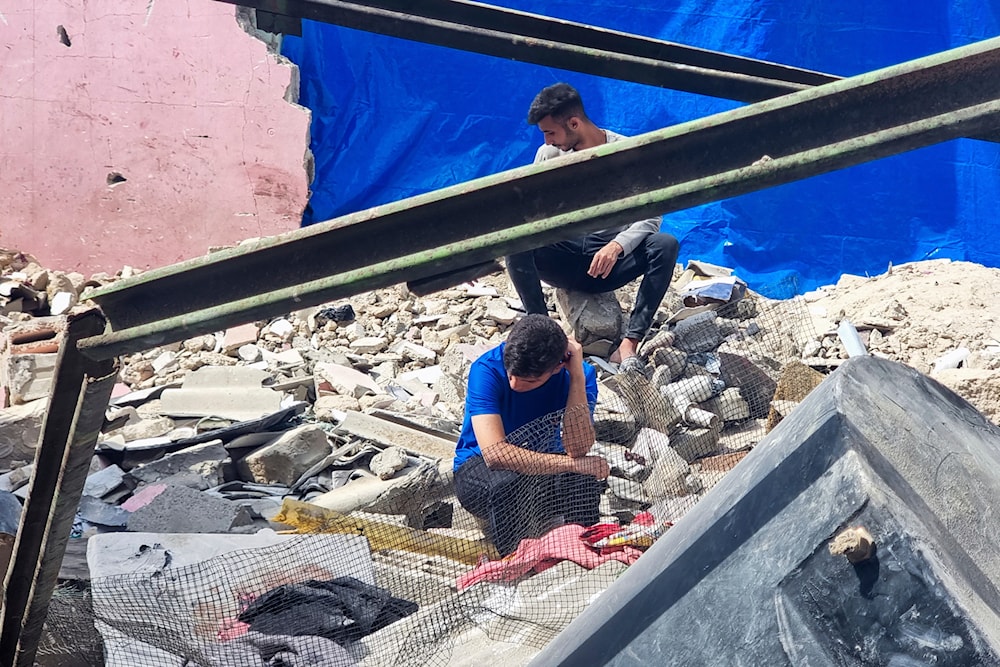 Palestinian civilians look at the destruction after an Israeli airstrike in Rafah, Gaza Strip, occupied Palestine, April 29, 2024 (AP)