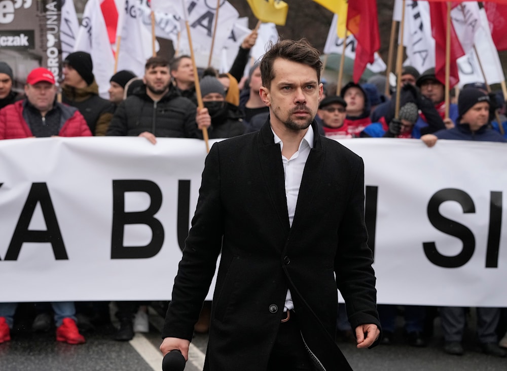 Leader of the Polish conservative agrarianism political movement Agrounia Michal Kolodziejczak, front, takes part in a protest against gas and fertilizer price hikes, in Warsaw, Poland, on February 23, 2022. (AP)