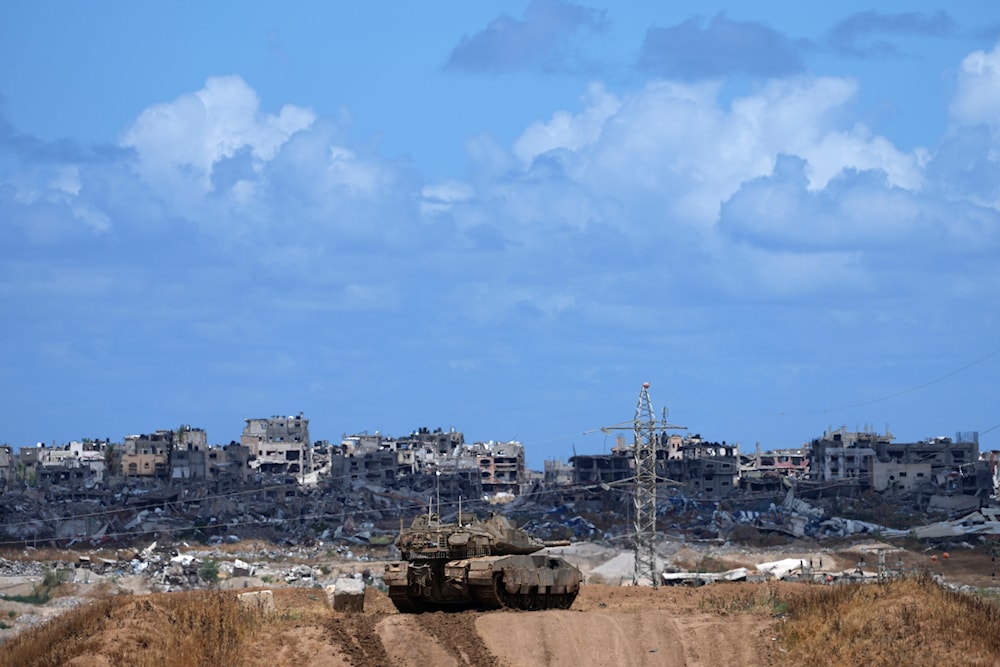 An Israeli tank overlooks the Gaza Strip, as seen from southern 'Israel', on May 6, 2024. (AP)