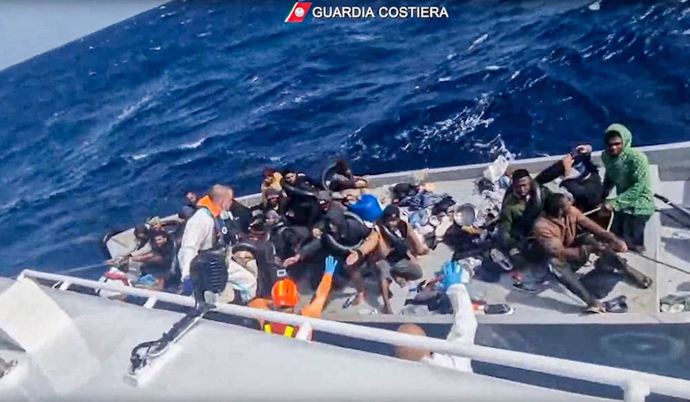 In this image from a video released by Italian Coast Guard on Thursday, April 11, 2024, a boat with migrants is approached by a rescue operation off the island of Lampedusa, Mediterranean Sea. (AP)