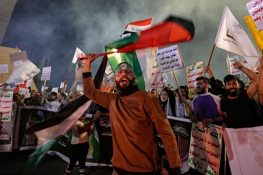Protesters chant slogans while waving Iraqi and Palestinian flags to show support for Palestinians in Gaza and to condemn Israeli attacks during a demonstration in Baghdad, Iraq, Saturday, March 30, 2024. (AP)