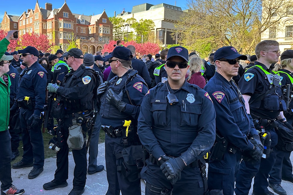 Police gather as they start removing tents erected by protesters from the campus of the University of Wisconsin in Madison on Wednesday, May 1, 2024, in Madison, Wis. Campus. (AP)