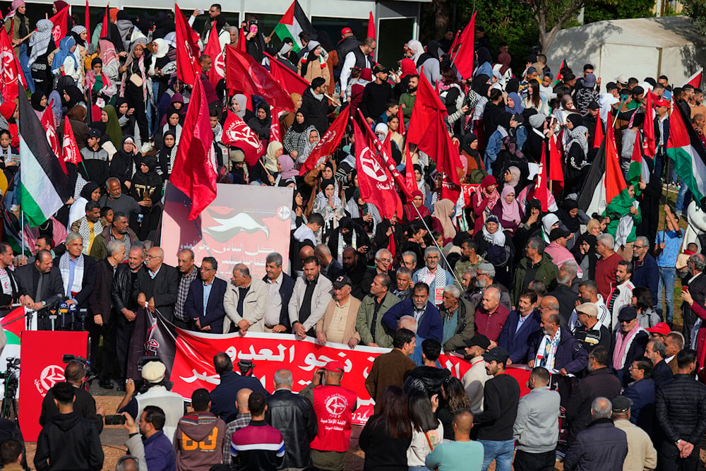 Supporters of the Popular Front for the Liberation of Palestine (PFLP), hold Palestinian and their group flags during a protest in solidarity with the Palestinian people in the Gaza Strip, in Beirut, Lebanon, December 17, 2023 (AP)