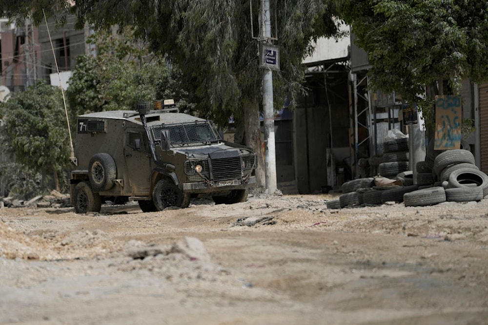 An Israeli occupation vehicle drives during a raid in the nearby Nur Shams refugee camp, near the West Bank town of Tulkarm, West Bank, Palestine, April 20, 2024. (AP)