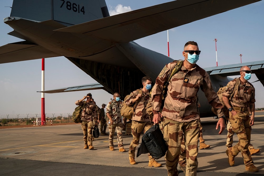 French soldiers disembark from a U.S. Air Force C130 cargo plane at Niamey, Niger base, on June 9, 2021 (AP)