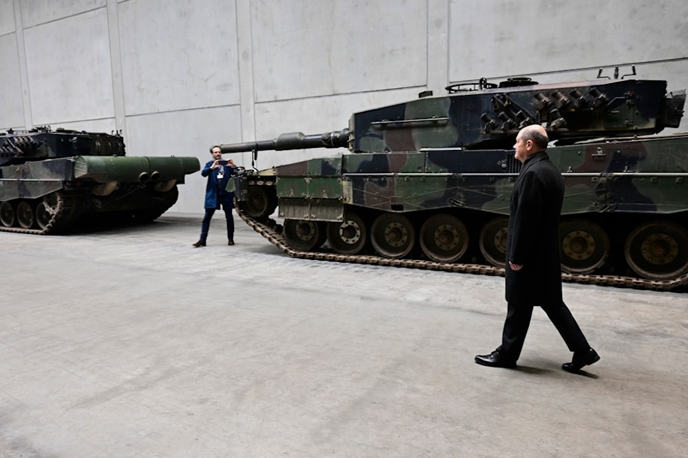 German Chancellor Olaf Scholz visits a production line at the future site of an arms factory where weapons maker Rheinmetall plans to produce artilleries from 2025, in Unterluess, Germany, Monday Feb. 12, 2024 (AP)