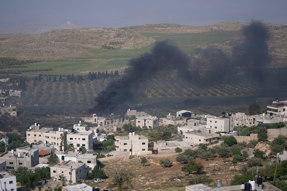 Smoke fills the sky after Israeli settlers set fire to the properties of Palestinian villagers in the West Bank village of al-Mughayyir, Saturday, April 13, 2024. (AP)