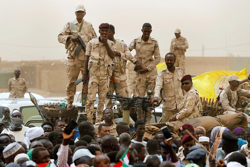 Sudanese soldiers from the Rapid Support Forces unit stand on their vehicle during a military-backed rally, in Mayo district, south of Khartoum, Sudan, Saturday, June 29, 2019 (AP)