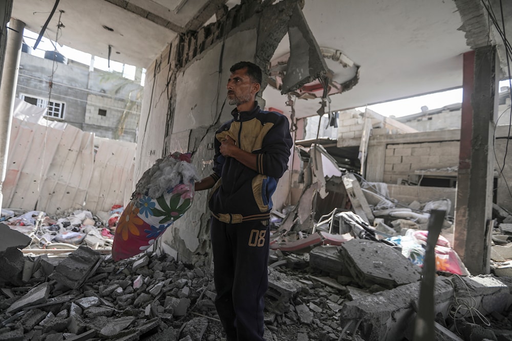 A Palestinian man stands in the ruins of the Chahine family home, after an overnight Israeli strike that killed at least two adults and five boys and girls under the age of 16 in Rafah, southern Gaza Strip, Friday, May 3, 2024. (AP)