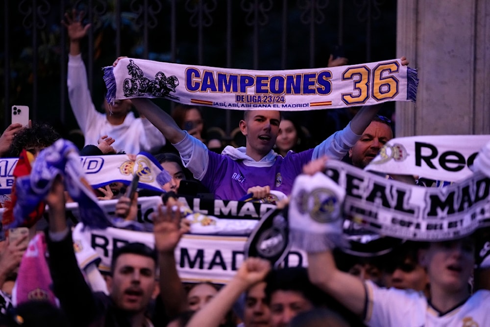 Real Madrid supporters celebrate in Cibeles Square in Madrid after their team clinched the La Liga title, Saturday, May 4, 2024 (AP)