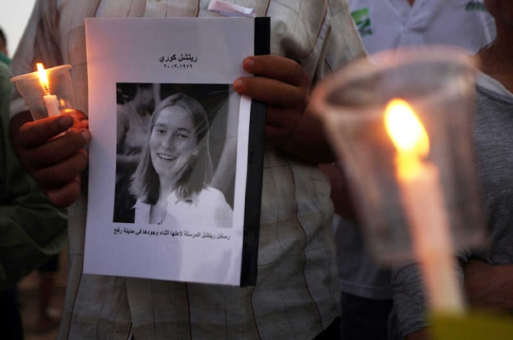 Palestinian children hold candles during a rally at a refugee camp in Rafah, in the southern Gaza Strip, in 2012, in memory of Rachel Corrie. (AFP)