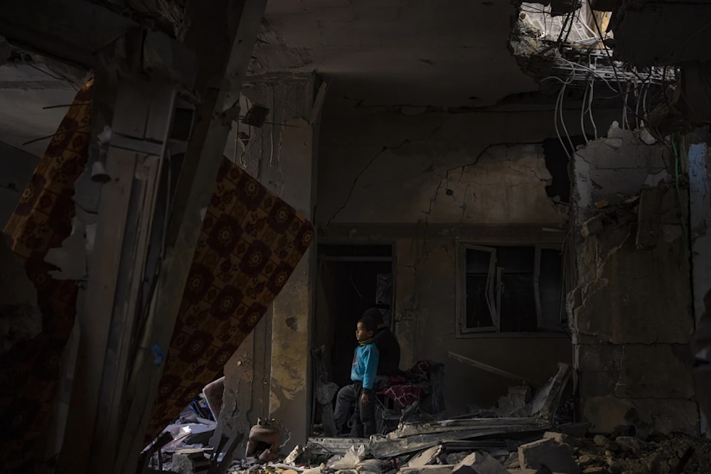 A Palestinian child looks at the damage to his family’s house after an Israeli strike in Rafah, on February 8, 2024. (AP) 