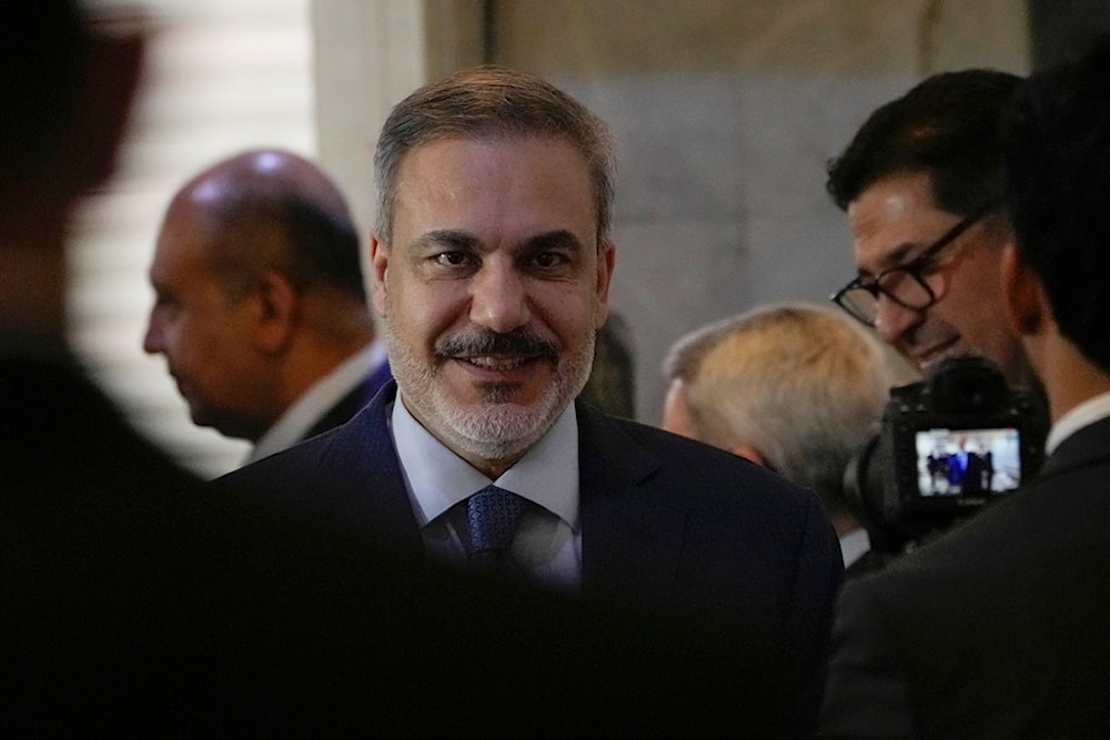 Turkish Foreign Affairs Minister Hakan Fidan, center, arrives at the foreign ministry in Baghdad, Iraq, Thursday, March 14, 2024. (AP)