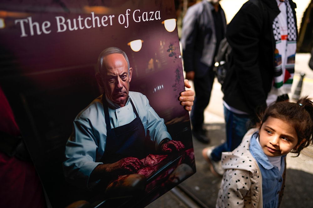 A girl looks at a poster of Israeli Prime Minister, Benjamin Netanyahu during a pro Palestinian protest in Istanbul, Turkey, Sunday, April 21, 2024. (AP)