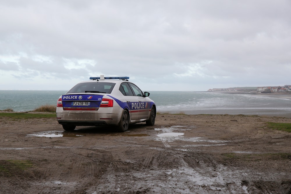 A police car parks over the shore in Wimereux, northern France, Thursday, Nov. 25, 2021 in Calais, northern France. (AP)