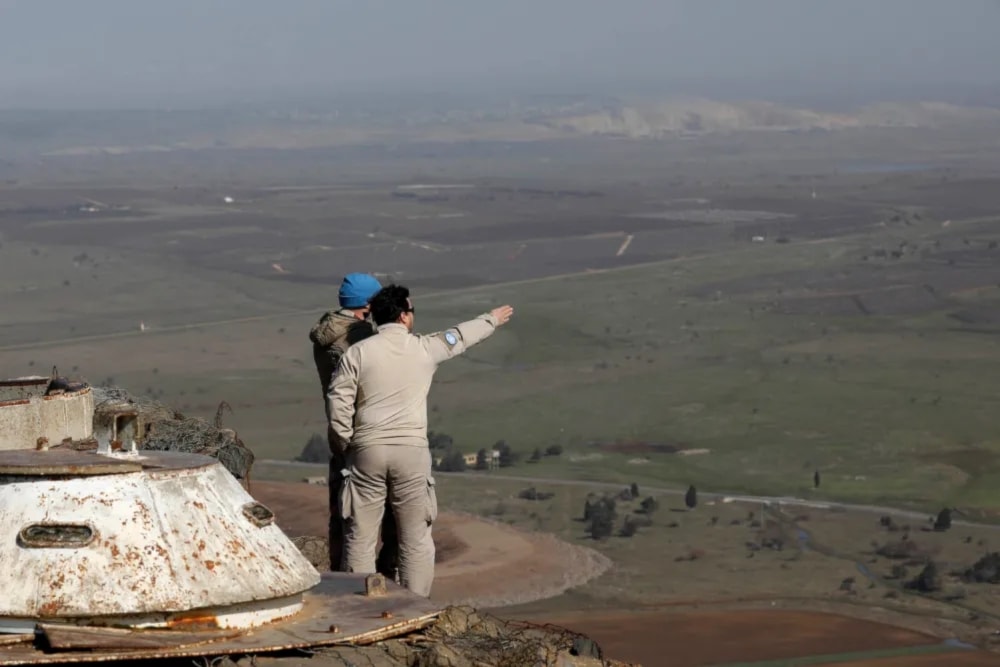 Illustrative: United Nations personnel stand at a lookout point as they monitor the Lebanese border with the occupied Golan Heights, on Jan. 21, 2019. (AFP/GETTY IMAGES)