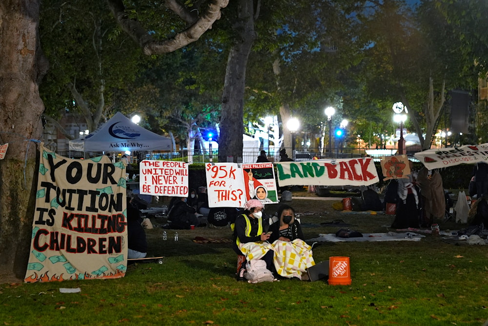 People stand guard outside an encampment set up by pro-Palestinian demonstrators on the campus at the University of Southern California Saturday, May 4, 2024, in Los Angeles. (AP)