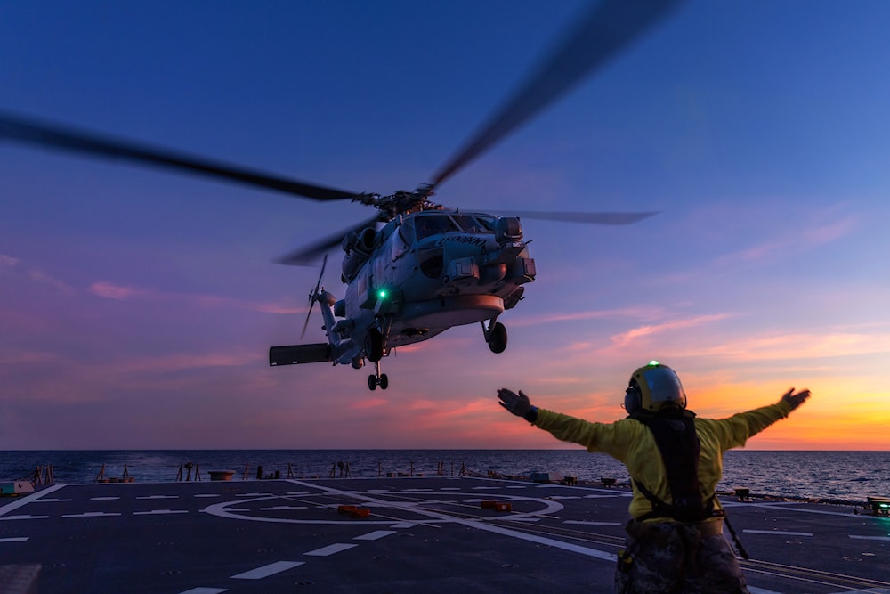 a Seahawk helicopter prepares to land on the deck of HMAS Hobart during flying operations while on a regional presence deployment off northern Australia (Australian Defence Force via AP)