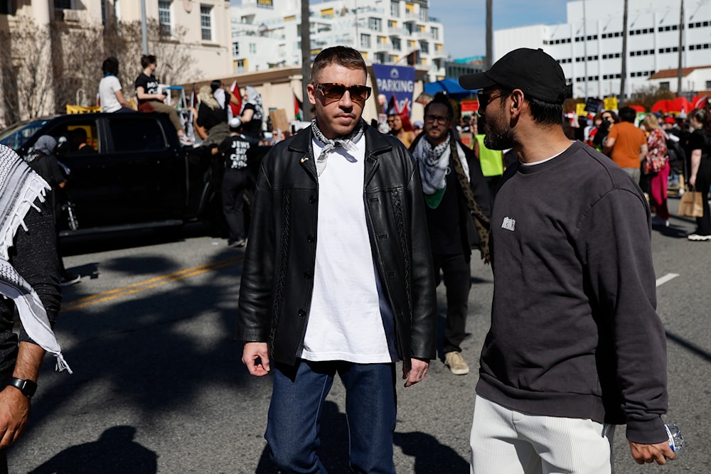 U.S. rapper Macklemore, center, attends a demonstration in support of Palestinians calling for a ceasefire in Gaza on March 10, 2024, in the Hollywood section of Los Angeles. (AP)