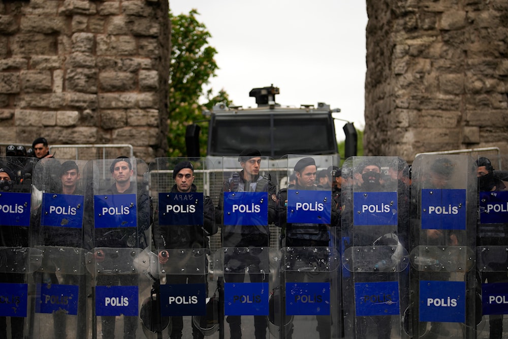 Anti riot police officers stand guard blocking the route to protesters as Union members march during Labor Day celebrations in Istanbul, Turkey, Wednesday, May 1, 2024. (AP)