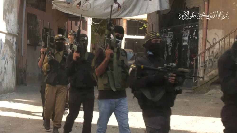A screenshot from the video showing members of the Tulkarm Brigade walking in the refugee camp on May 2, 2024. (military media)