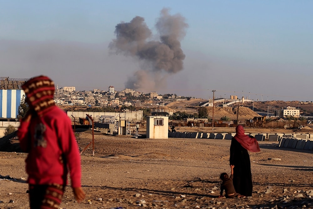 Smoke rises following an Israeli airstrike on buildings near the separating wall between Egypt and Rafah, southern Gaza Strip, Tuesday, May 7, 2024. (AP)