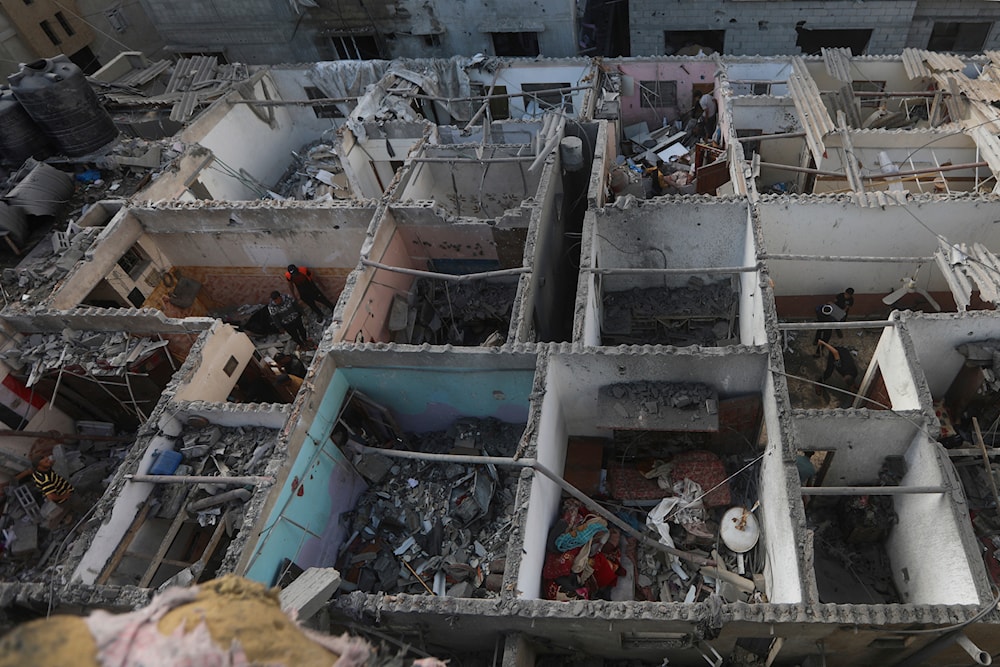 Palestinians look at the destruction caused by an Israeli strike on a residential building in Rafah, Gaza Strip, Tuesday, May 7, 2024. (AP)